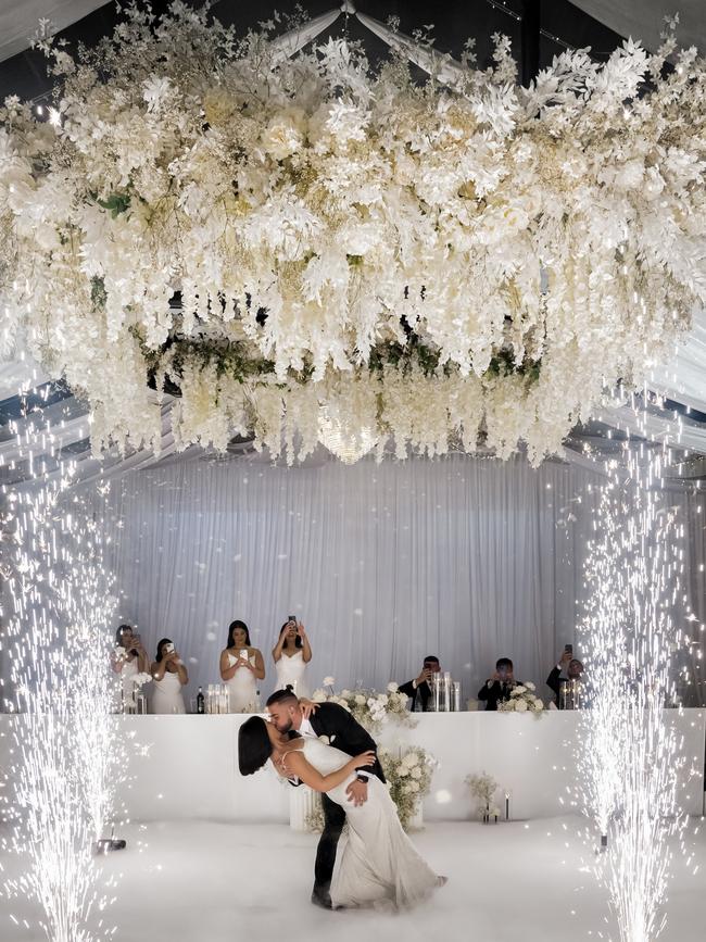 A spectacular floral chandelier and pyrotechnics greeted the happy couple at the reception. Photographer: Ky Luu – B Captured