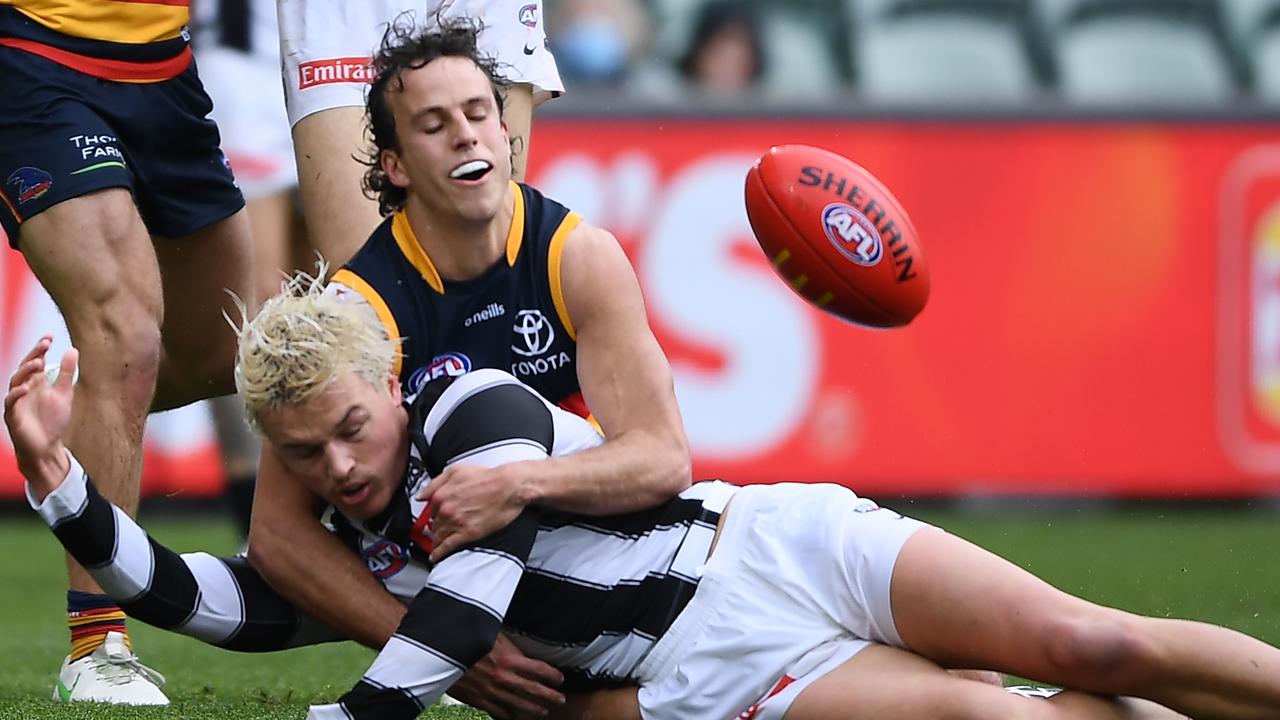 Jack Ginnivan is caught high by Adelaide’s Will Hamill.