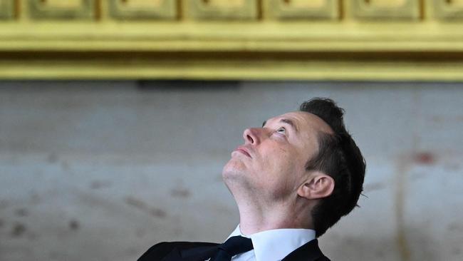 Elon Musk looks upward as he sits during the inauguration ceremony. Picture: AFP