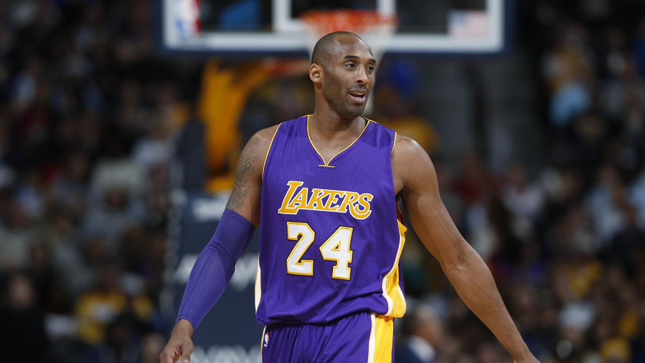 Los Angeles Lakers forward Kobe Bryant jokes with members of the Denver Nuggets in the first half of an NBA basketball game Tuesday, Dec. 22, 2015, in Denver. (AP Photo/David Zalubowski)
