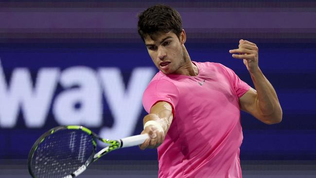 Carlos Alcaraz of Spain returns a shot to Taylor Fritz. Matthew Stockman/Getty Images