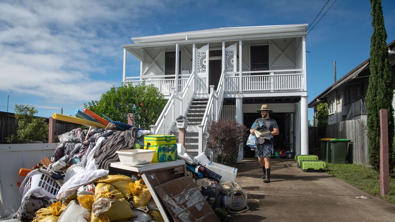 Murray Thomas adds to the rubbish pile in at the front of his Blackmore street home. Picture: Brad Fleet