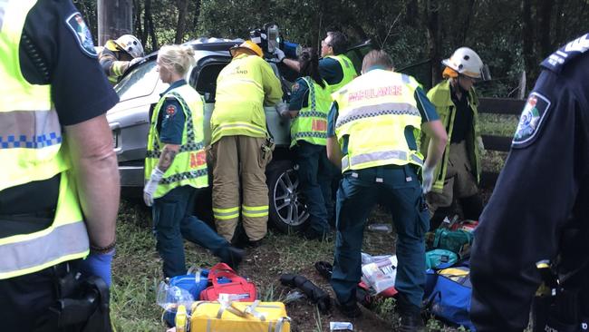 Emergency services on the scene of a car which began smoking after it collided with a power pole at West Woombye on Saturday afternoon.