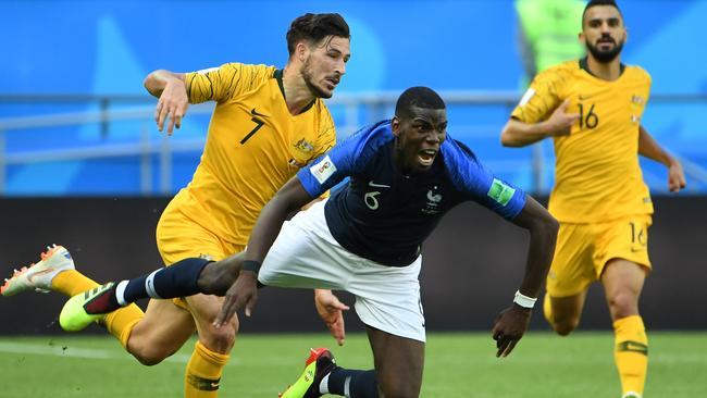 Paul Pogba goes down under a challenge from Mathew Leckie.