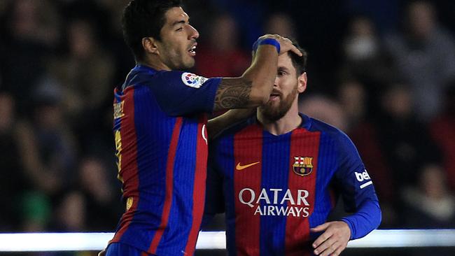 FC Barcelona's Lionel Messi, right, celebrates after scoring with his teammate Luis Suarez.