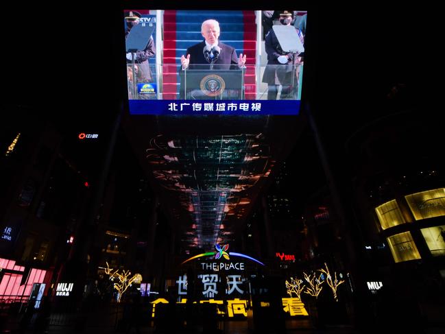 The inauguration of US President Joe Biden is seen on a giant screen outside a shopping mall in Beijing. Picture: AFP