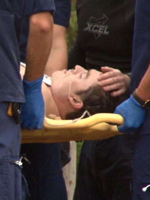 Josh Bush is treated by paramedics and comforted by family and friends. Picture: TNV