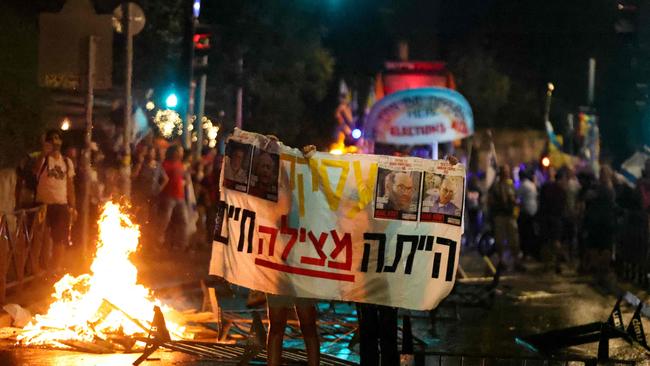 A protester holds a sign during a demonstration against Israeli Prime Minister Benjamin Netanyahu’s government. Picture: AFP