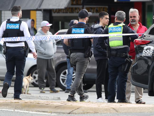 Police chat to onlookers. Picture: David Crosling