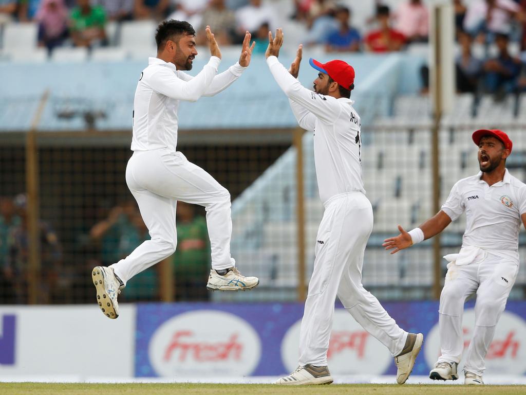 Rashid Khan celebrates taking a wicket in a Test against Bangladesh.