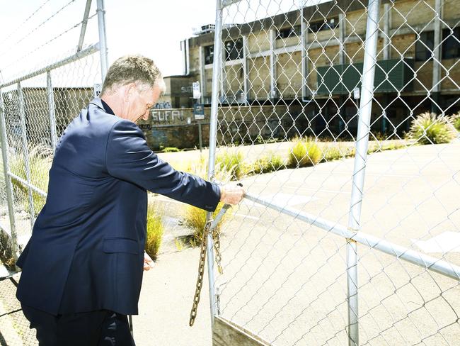 Managing Director of Heworth Brian Hood opens the gate to the Balmain Leagues Club site in Rozelle. Picture: John Appleyard