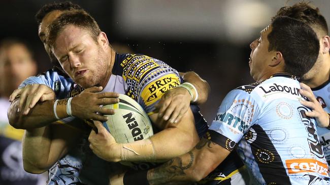 Gavin Cooper of the Cowboys is tackled during the round 22 NRL match against the Sharks.