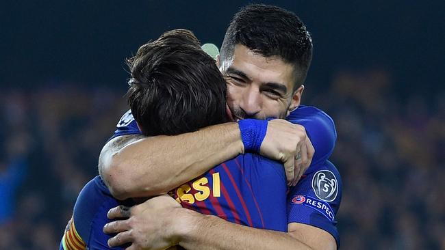 Barcelona's Argentinian forward Lionel Messi celebrates with Barcelona's Uruguayan forward Luis Suarez (back)