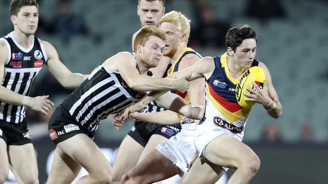 Adelaide’s Chayce Jones tries to break a Willem Drew tackle. Picture: SARAH REED