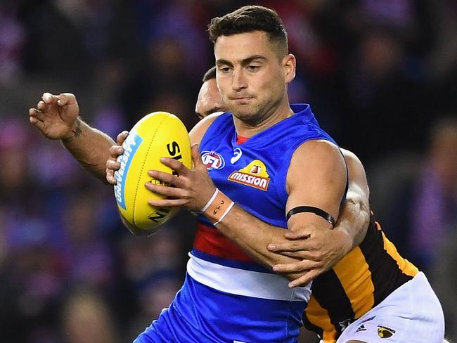 MELBOURNE, AUSTRALIA - JULY 07:  Luke Dahlhaus of the Bulldogs is tackled by Jarman Impey of the Hawks  during the round 16 AFL match between the Western Bulldogs and the Hawthorn Hawks at Etihad Stadium on July 7, 2018 in Melbourne, Australia.  (Photo by Quinn Rooney/Getty Images)