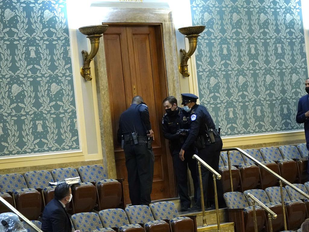 US Capitol Police draw their guns as protesters attempt to enter the House Chamber. Picture: AFP