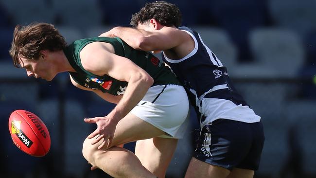 Ballarat’s Mitch Fino puts pressure on Hampden’s Ryley Hutchins. Picture Yuri Kouzmin