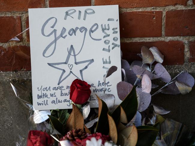 A message is left with flowers and tribute outside the Oxfordshire home of British pop singer George Michael in Goring, England. Picture: Getty