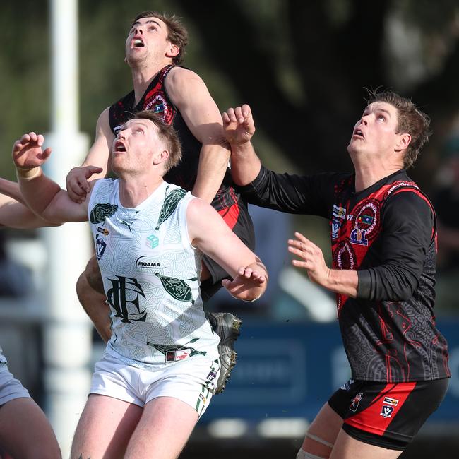 Kyabram’s Kyle Mueller uses Echuca opponent Cameron Valentine as a step ladder.