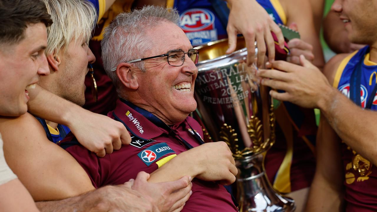 MELBOURNE, AUSTRALIA - SEPTEMBER 28: Chris Fagan, Senior Coach of the Lions celebrates with his team during the 2024 AFL Grand Final match between the Sydney Swans and the Brisbane Lions at The Melbourne Cricket Ground on September 28, 2024 in Melbourne, Australia. (Photo by Dylan Burns/AFL Photos via Getty Images)