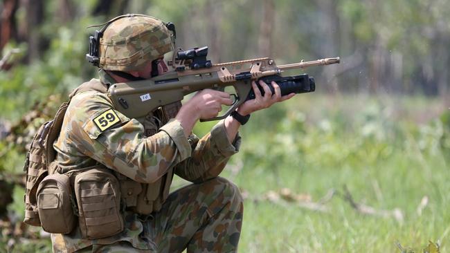 Private Jackson Bartlett from the 5th Battalion Royal Australian Regiment pulls the then 2013 newly position trigger on the new Grenade Launcher Attachment (GLA) on an EF88 Austeyr weapon at Kangaroo Flats firing range, outside of Darwin. Picture: