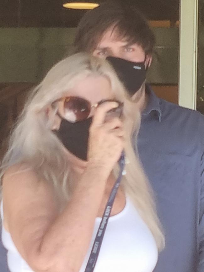 Nathan Fenwick hides behind his mother after leaving court for preying on a student at a Whyalla school. Photo: Lucy Rutherford