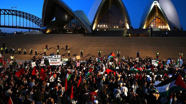 Participants of a Free Palestine rally react outside Sydney Opera House in Sydney.