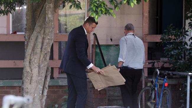 Police conduct a search following the fatal house fire. Picture: David Swift