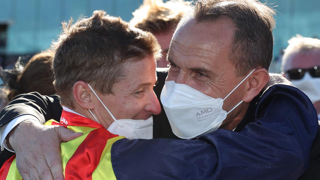 McDonald embraces trainer Chris Waller. Picture: AFP