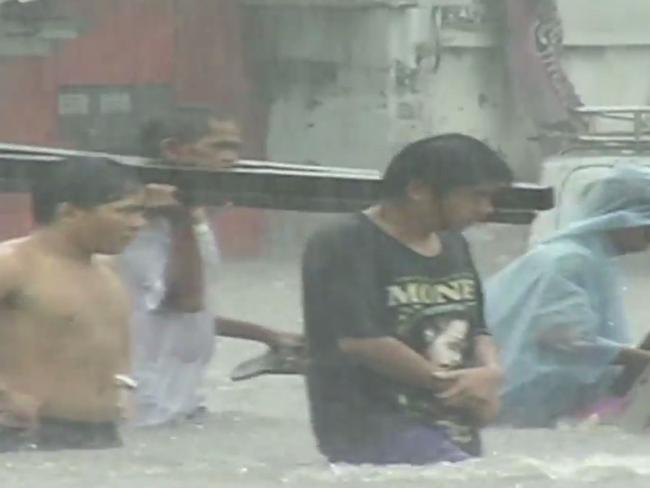 Families escaping their ruined homes after floods. Picture: WMO