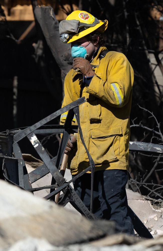 A firefighter works in residential damage from the Eaton fire as wildfires cause damage and loss through the LA region on January 14 in Altadena, California. Picture: Benjamin Fanjoy/Getty Images via AFP