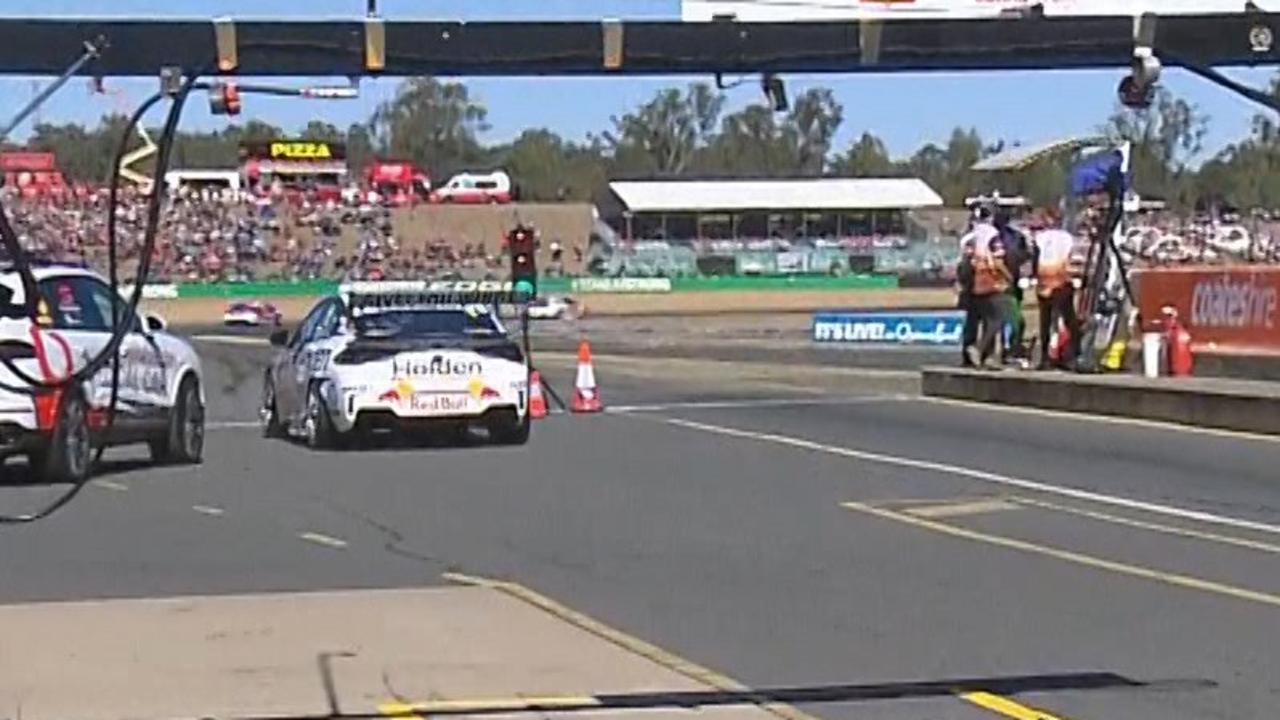 Jamie Whincup exiting pit lane on the wrong side of the cones, not in the fast lane.