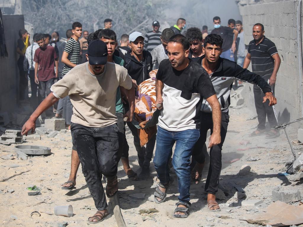 Palestinian emergency services and local citizens carry a victim of Israeli air raids in the southern Gaza Strip in Khan Yunis. Picture: Getty Images