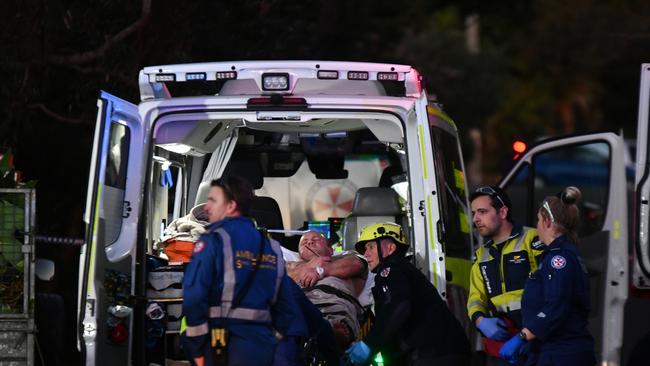 John Dunne being taken to hospital. Picture: Sebastien Dekker