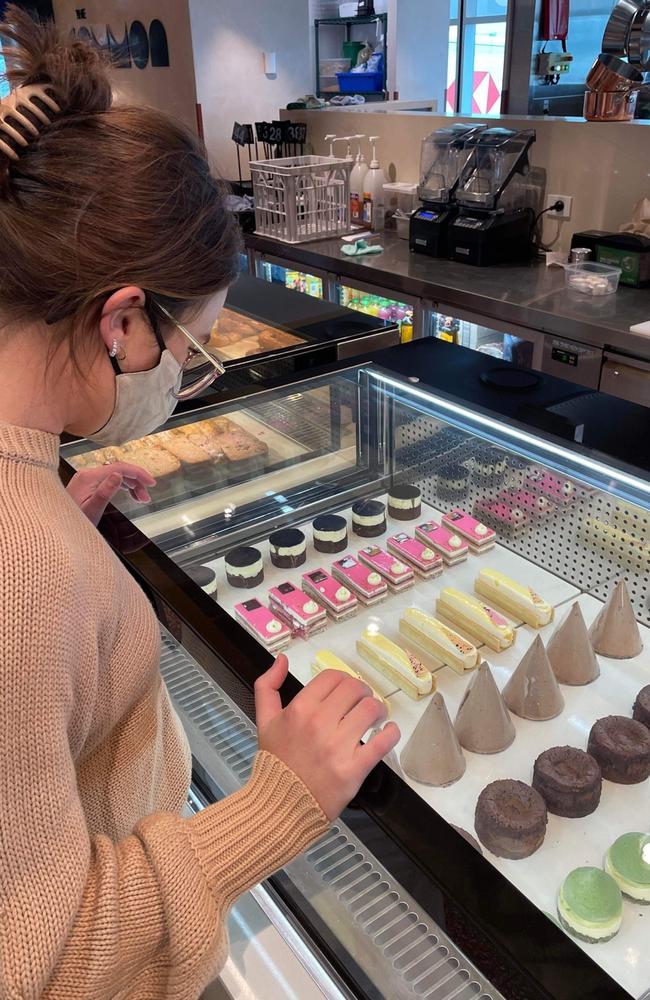 Traveller Rachelle Moore inspecting The Common’s cabinet display in an Instagram story. Photo - contributed.