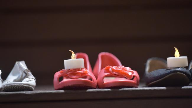 Shoes and candles represent victims of domestic violence on National Domestic Violence Day to Remember.