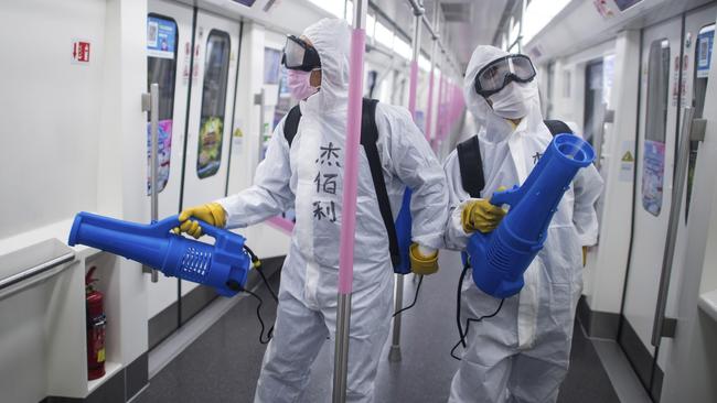 Workers disinfect a subway train in preparation for the restoration of public transport in Wuhan, in central China's Hubei province. Picture: Xiao Yijiu/Xinhua via AP