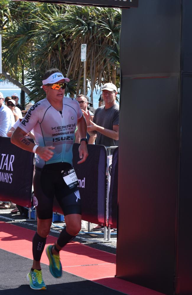 Athletes crossing the finish line at Sunshine Coast Ironman 70.3 2023.