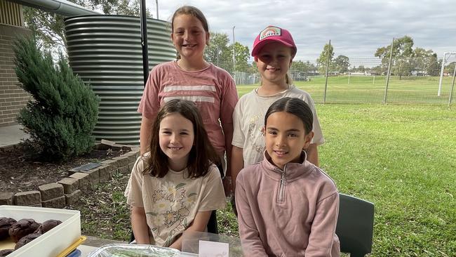 Toongabbie Public School students raise funds for their band on election day. Front: Annalie Dabinett and Adelin Kari. Back: Eva Medved and Anabelle Smith.