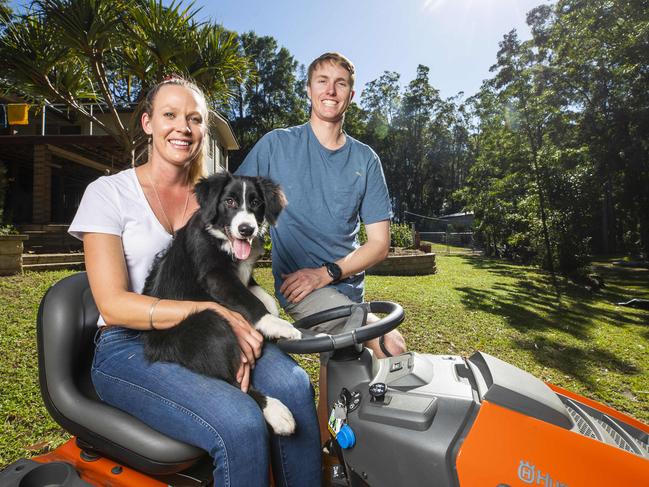 Tegan Madden, 26, with partner James Widdicombe, 28, and puppy Ace, who recently purchased an acreage at Pomona in the Noosa Hinterland, say they have enjoyed the time in isolation. Picture: Lachie Millard