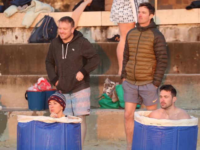 The first day of winter was a chilly nine degrees at Coogee on Wednesday, 2022. Brave participants sit in a bucket of Ice on Coogee beach. Picture: John Grainger