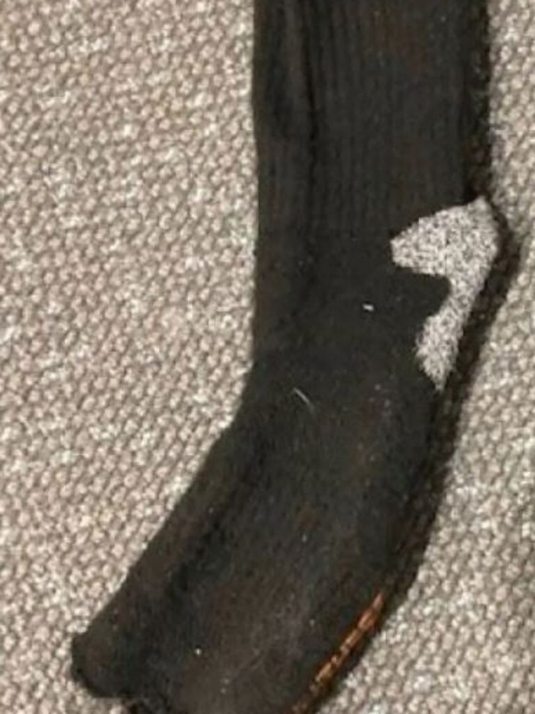 A hole through the heel of Mr Gow’s sock can be spotted.