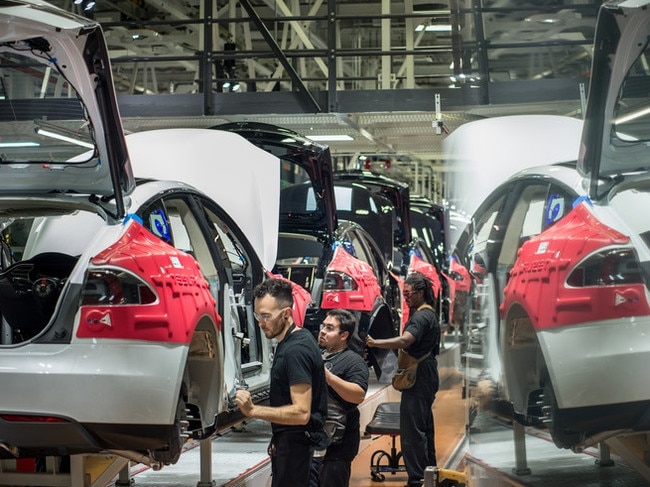 Tesla workers assembled cars at the company’s factory in Fremont, Calif., last year. Tesla has sold about 140,000 cars since 2008 and is aiming to churn out a million a year by the end of 2020. PHOTO: DAVID BUTOW/CORBIS/GETTY IMAGES