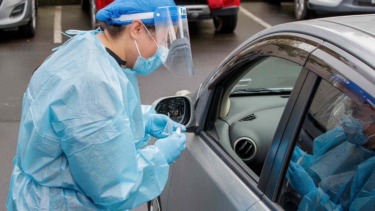 A health worker conducts a COVID-19 test in Auckland on Tuesday after the country ended its more than 100-day run of no known locally transmitted cases. Picture: David Rowland/AFP