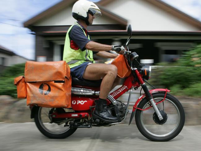 NEWS: Generic pic of an Australia Post worker (postman) on his motorbike (motorcycle) in Sydney. New regulations have raised the maximum weight for the rider from 95 to 105 kilograms.