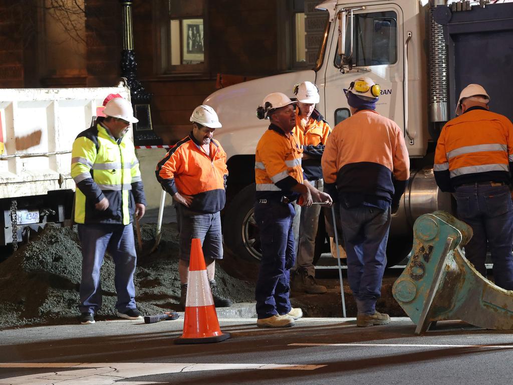 Workers taking measurements. Work in Macquarie Street Hobart on the hole that will house the chamber performance artist Mike Parr will live in for 72 hours during Dark Mofo. Picture: NIKKI DAVIS-JONES