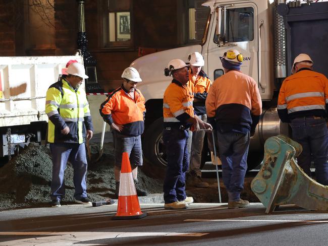 Workers taking measurements. Work in Macquarie Street Hobart on the hole that will house the chamber performance artist Mike Parr will live in for 72 hours during Dark Mofo. Picture: NIKKI DAVIS-JONES