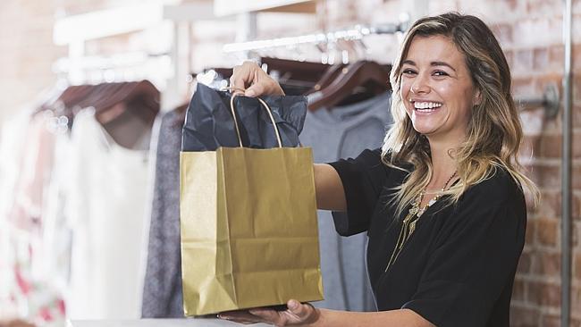 Young woman with shopping bag in clothing store