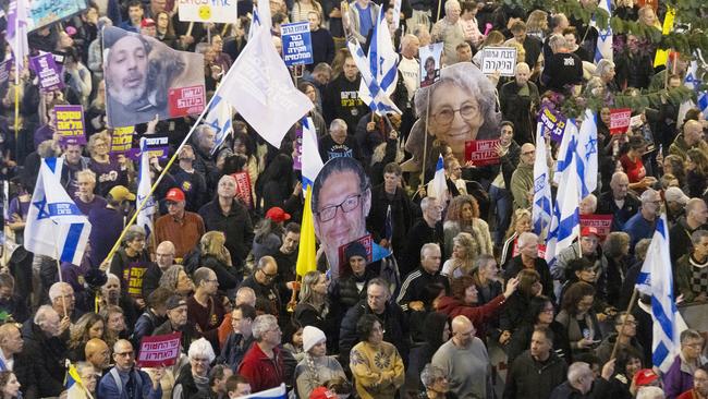 Protesters in Tel Aviv hold photos of hostages held in the Gaza Strip in front of the Ministry of Defense. Picture: Getty Images