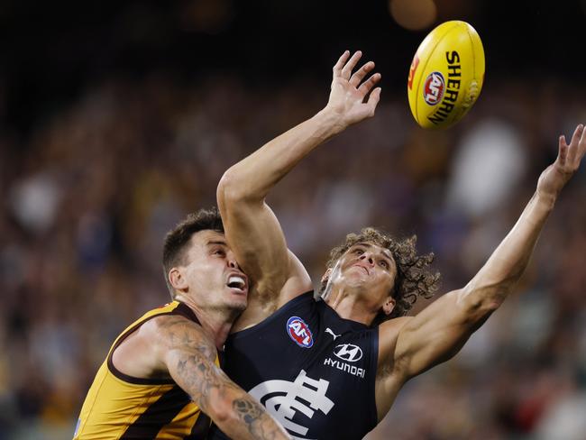 Charlie Curnow tries to mark in front of Josh Battle on Thursday night. Picture: Michael Klein